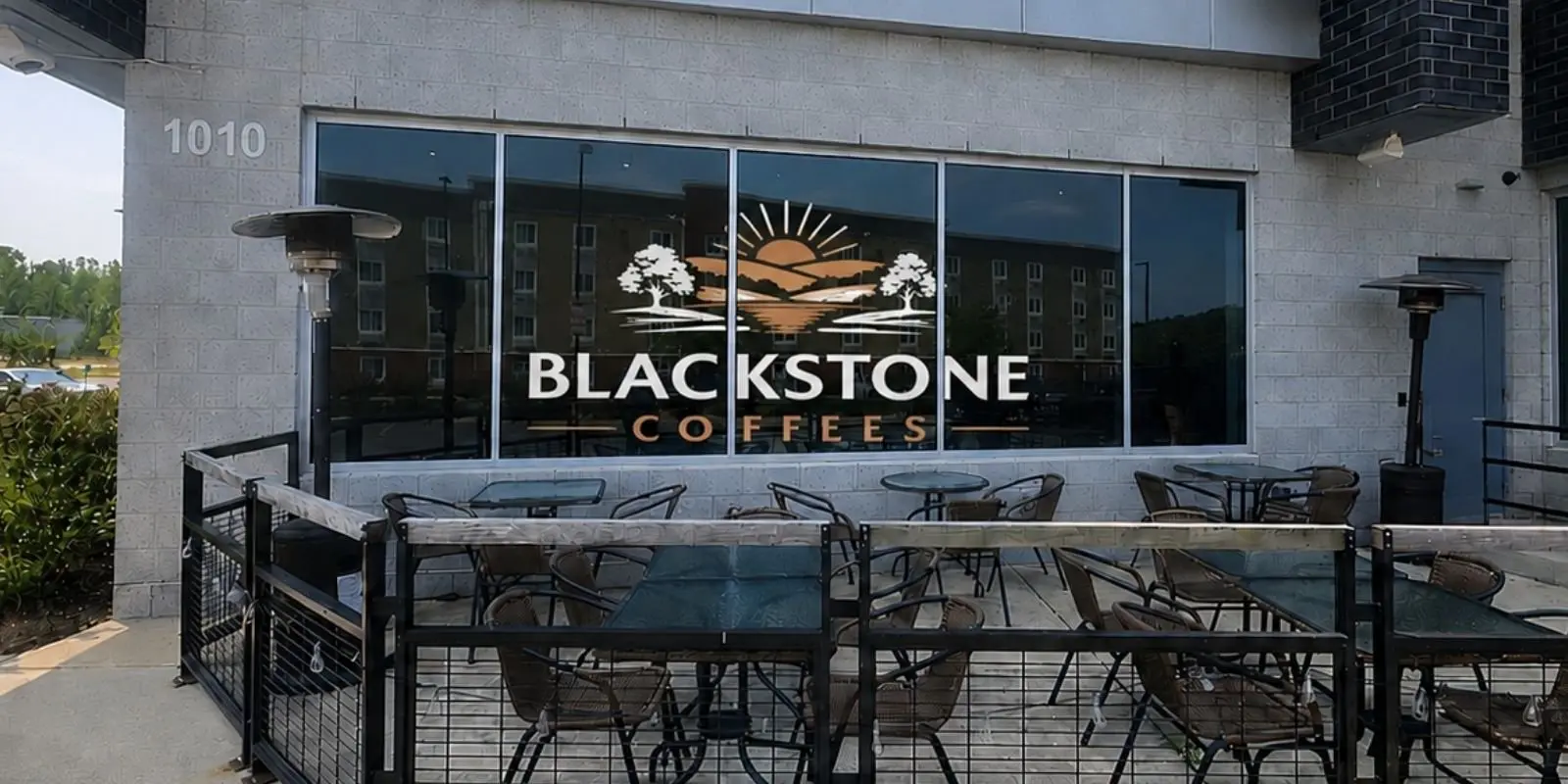 Blackstone Coffees storefront at the Quantico Cyber Hub, with the Blackstone Coffees logo on the front window above the outdoor patio